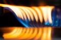 A Macro Image of a Blurry Blue and Yellow Flames on Gas Stove Burner Royalty Free Stock Photo