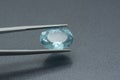 Macro image of carved aquamarine gemstone clamped