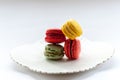 Macro image of colourful macarons on a white plate Royalty Free Stock Photo