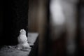 Tiny snowman on a railing after a snow storm