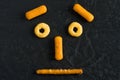 Macro Image of Funny Face Made with Snacks on Dark Background Royalty Free Stock Photo