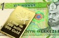 A green one manat bill from Turkmenistan with a gold bar in macro Royalty Free Stock Photo