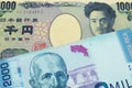 A Japanese thousand yen note paired with a colorful two thousand colones bank note from Costa Rica.