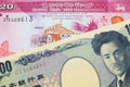 A Japanese thousand yen note paired with a pink and white twenty rupee bank note from Sri Lanka.