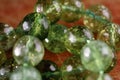 Macro image of natural mineral rock specimen in form of round bead from green jade gemstone