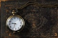 Macro image of old vintage pocket watch on antique book. top view. retro filtered image