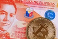 Twenty Filipino peso bank note with a golden bitcoin