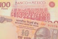 A orange ten rupee bill from India paired with a red and yellow one hundred peso bill from Mexico.