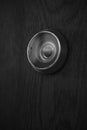 Macro image of a peephole on a wooden door, bw