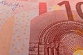 A macro image of the red microprint, sign, watermark on a Ten Euro banknote, emphasizing the advanced tamper-proof