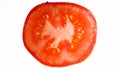 Macro photo of red ripe tomato slice on white background. Abstract background of vegetables and fruits Royalty Free Stock Photo