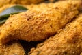 Macro image of seasoned cornmeal breading on a fried catfish fillet, revealing the various herbs and spices used