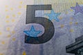 A macro image of the special ink on a Euro banknote, showcasing the security measures in place to prevent counterfeiting