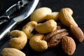 Macro Image of Walnuts, Cashews and Pecans with Chromed Nut Cracker
