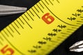 A macro image of a yellow Tape Measure