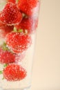 Macro Macro of isolated cocktail glass with red strawberries, sparkling water focus on bubbles Royalty Free Stock Photo