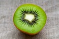 Macro kiwi fruit close up on hessian linen fabric