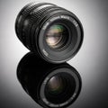 8 macro lens resting on a reflective surface, capturing its reflection Royalty Free Stock Photo