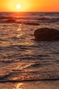 Macro low shot of the sea and orange sunset. Royalty Free Stock Photo