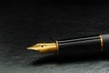 Luxury black gold plated fountain pen on black leather with  copy space Royalty Free Stock Photo