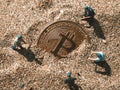 Macro miner figurines digging ground to uncover big shiny bitcoin