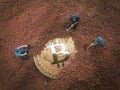 Macro miner figurines digging ground to uncover big shiny bitcoin