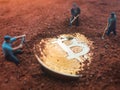 Macro miner figurines digging ground to uncover big shiny bitcoin