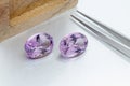 Macro mineral faceted stone cut Amethysts on a gray background