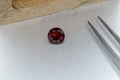 Macro mineral faceted stone cut Garnet on a gray background Royalty Free Stock Photo