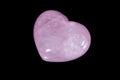 Macro mineral stone Heart pink quartz on a black background Royalty Free Stock Photo