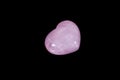 Macro mineral stone Heart pink quartz on a black background Royalty Free Stock Photo