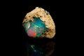 Macro mineral stone rare and beautiful opals on a black background Royalty Free Stock Photo