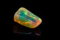 Macro mineral stone rare and beautiful opals on a black background Royalty Free Stock Photo