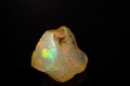 Macro mineral stone rare and beautiful opals on a black background Royalty Free Stock Photo