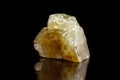 Macro mineral stone yellow Calcite on a black background