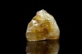 Macro mineral stone yellow Calcite on a black background