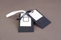 macro mock up empty black and white paper tag with black and white satin ribbon for brand logo on green cotton material