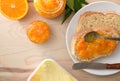Macro of orange jam jar on bread and containers Royalty Free Stock Photo