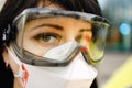 Macro: Paramedic looks at you wearing protective goggles and respirator