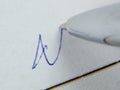 macro pen and handwritten signature on white paper, selective focus. Contract conclusion concept Royalty Free Stock Photo