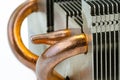 Macro photo of an aluminum heat sink from a pc with visible copper heat dissipation tubes.