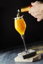 Macro Photo of Bartender Hand Preparing Classic Bellini Cocktail
