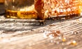 Macro photo of a bee hive on a honeycomb. Sweet honey, pieces of combs and honey dipper