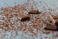 Macro photo of Broken pieces Chocolate bar. Dark chocolate stack with brown powder on a stone background with copy space Royalty Free Stock Photo