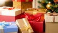 Macro image of colorful silk ribbons and bows on Christmas gifts boxes under Xmas tree Royalty Free Stock Photo