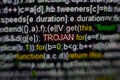 Macro photo of computer screen with program source code and highlighted TROJAN inscription in the middle. Script on the Royalty Free Stock Photo