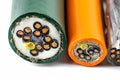 Macro photo of the cross section of various electric cables, isolated on a white background.