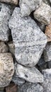 Macro photo of crushed stone and gravel on the ground. Texture background white gray stones on a black earth background. Royalty Free Stock Photo