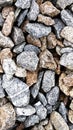 Macro photo of crushed stone and gravel on the ground. Texture background white gray stones on a black earth background. Royalty Free Stock Photo