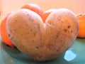 Macro photo with a decorative background of a figured potato vegetable in the shape of a heart